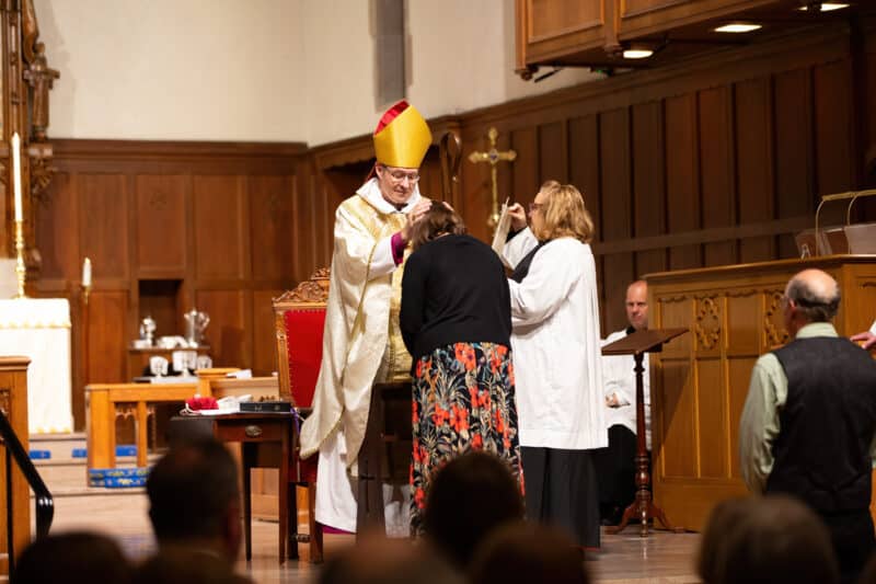Bishop Stevenson praying over confirmand during ceremony at St. Stephen's Church in Richmond, Virginia