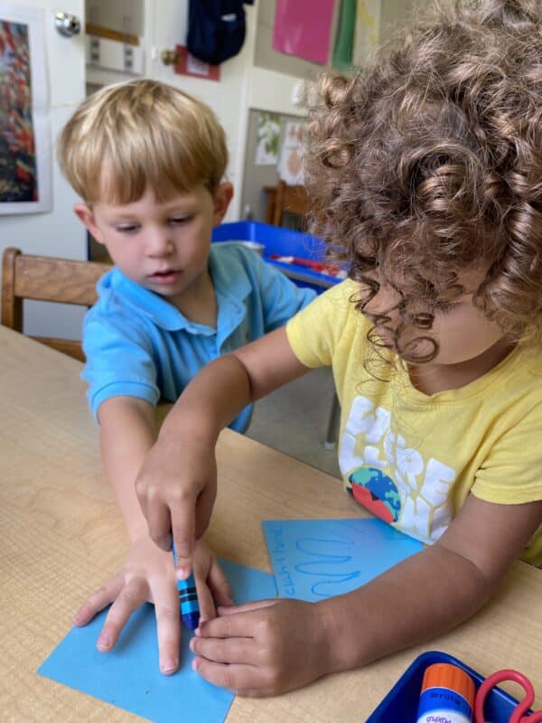 Two children coloring with crayons at Dogwood Preschool