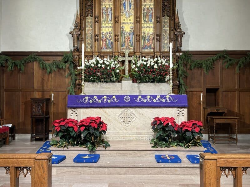 Christmas greenery and flowers adorning church altar at St. Stephen's Church in Richmond, Virginia